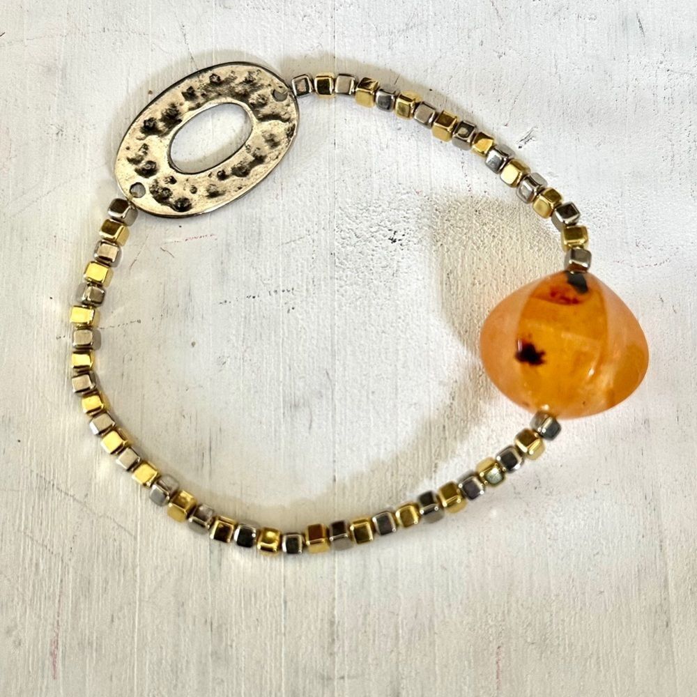 Silver and gold tone bracelet with orange bead